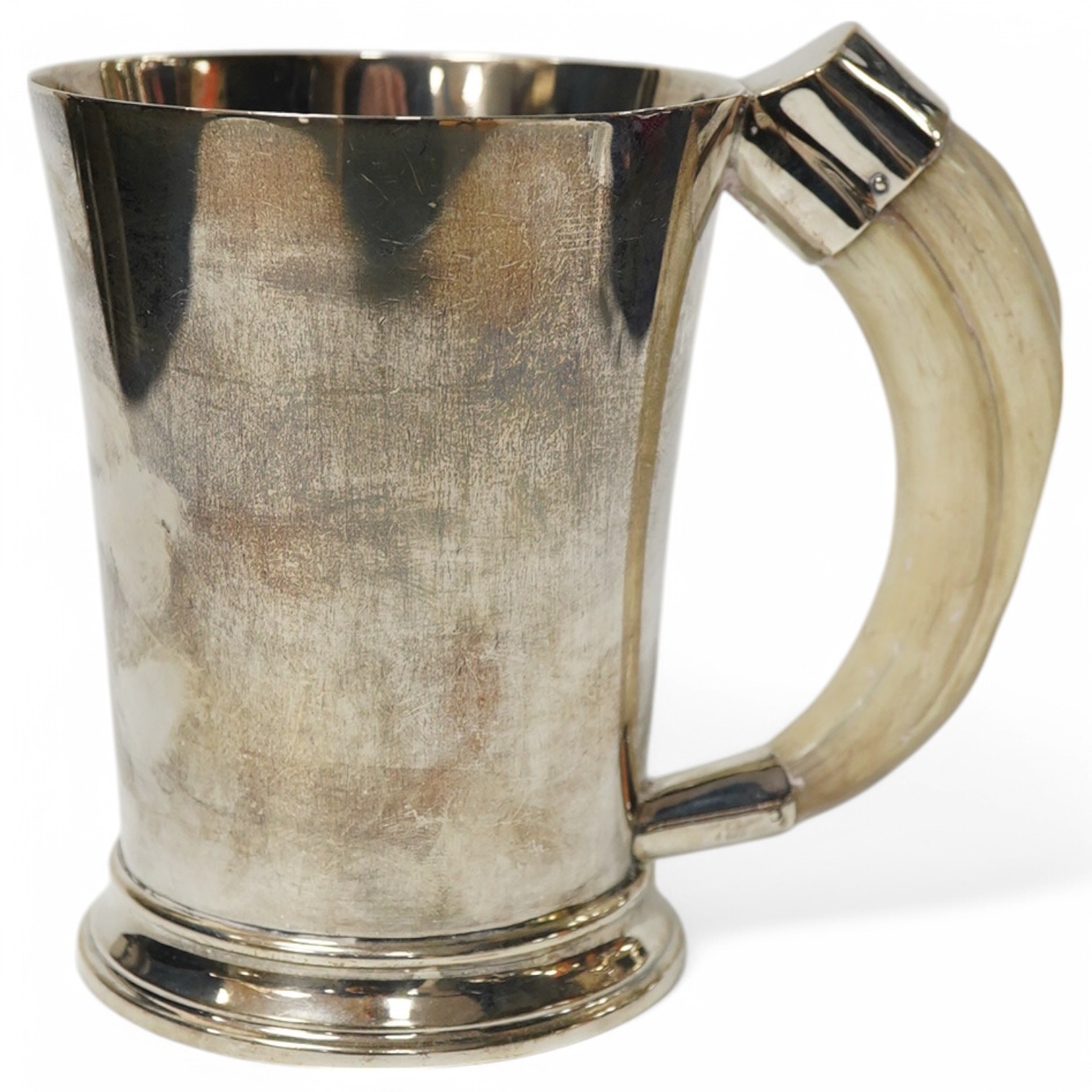 A George VI silver mug with a boar’s tusk handle, Hukin & Heath, Birmingham, 1938, height 11.8cm, gross weight 11.7oz. Condition - fair